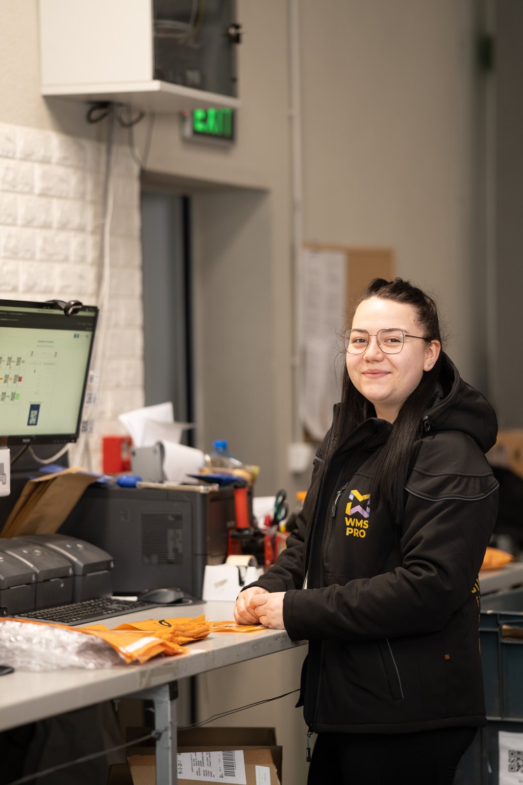 Pick and pack operation at the BigArena fulfilment center — operator picking SKUs for an order